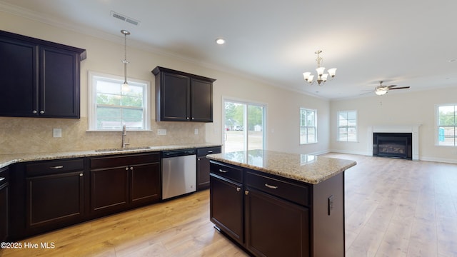 341 Oleander Dr, Greenville, NC 27858 - kitchen with dishwasher, a chandelier, ornamental molding, a glass covered fireplace, and light wood finished floors