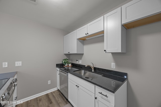 6739 Newbury Way, Wilmington, NC 28411 - kitchen featuring stainless steel appliances, dark wood finished floors, dark stone countertops, and white cabinets