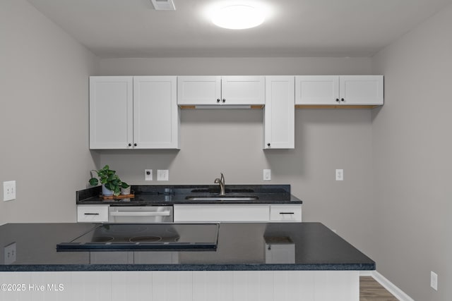 6739 Newbury Way, Wilmington, NC 28411 - kitchen featuring dark countertops, white cabinets, dishwasher, and cooktop