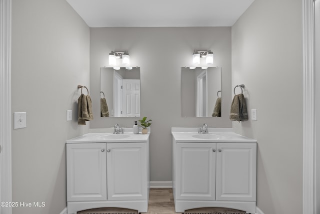 6739 Newbury Way, Wilmington, NC 28411 - bathroom with two vanities and wood finished floors