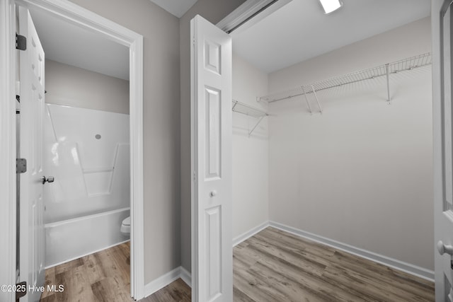 6739 Newbury Way, Wilmington, NC 28411 - bathroom featuring wood finished floors, shower / tub combination, and a spacious closet