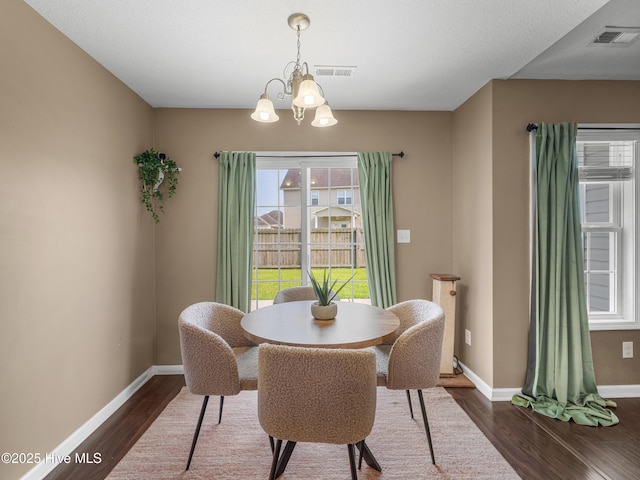 206 Riverstone Ct, Jacksonville, NC 28546 - dining area with dark wood-type flooring and a chandelier