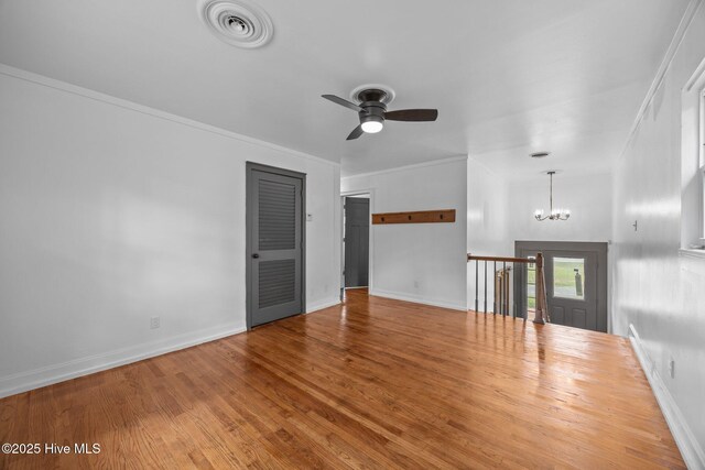 1955 Banks School Rd, Kinston, NC 28504 - unfurnished living room with a chandelier, wood finished floors, ceiling fan, and ornamental molding