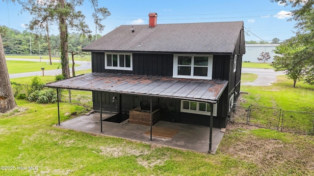 1955 Banks School Rd, Kinston, NC 28504 - rear view of property featuring board and batten siding, a patio area, roof with shingles, a chimney, and a gate