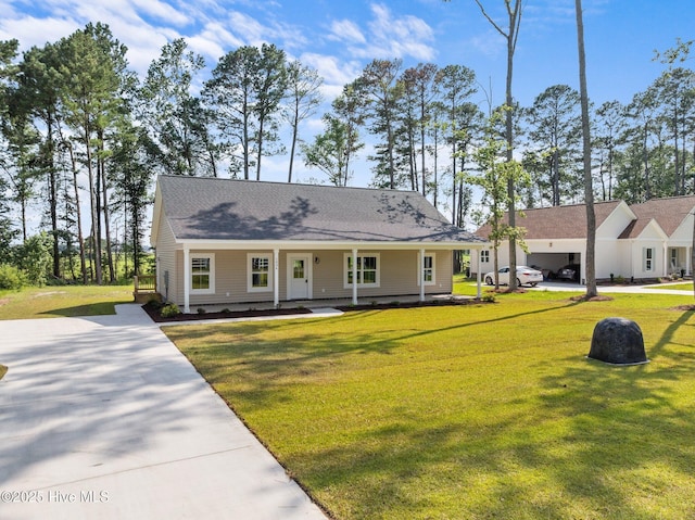 1034 Powers Ln, Winterville, NC 28590 - view of front of property with concrete driveway, a porch, a front yard, and a carport