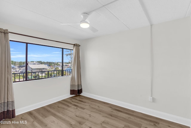 222 Carolina Beach Ave N Unit 230, Carolina Beach, NC 28428 - empty room with wood finished floors and ceiling fan