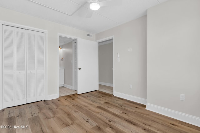 222 Carolina Beach Ave N Unit 230, Carolina Beach, NC 28428 - unfurnished bedroom featuring wood finished floors, connected bathroom, a closet, and ceiling fan