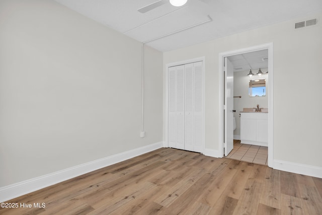 222 Carolina Beach Ave N Unit 230, Carolina Beach, NC 28428 - unfurnished bedroom with light wood finished floors, a closet, and ensuite bath