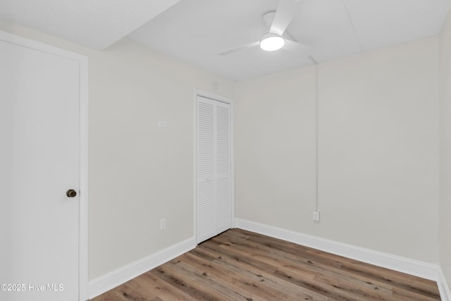 222 Carolina Beach Ave N Unit 230, Carolina Beach, NC 28428 - unfurnished bedroom featuring wood finished floors, a closet, and a ceiling fan