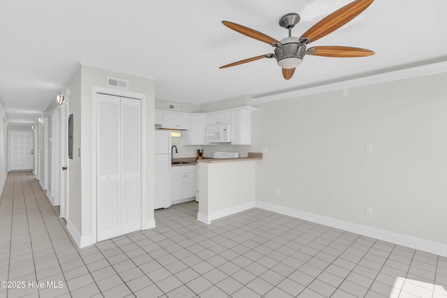 222 Carolina Beach Ave N Unit 230, Carolina Beach, NC 28428 - kitchen with white appliances, ceiling fan, white cabinetry, crown molding, and light countertops