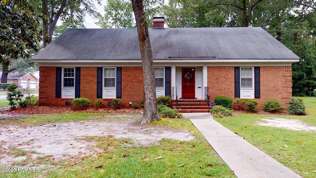 707 S Claiborne St, Goldsboro, NC 27530 - view of front of home with a chimney, a front lawn, brick siding, and roof with shingles