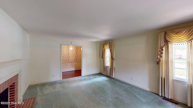 707 S Claiborne St, Goldsboro, NC 27530 - unfurnished living room with a fireplace and carpet flooring