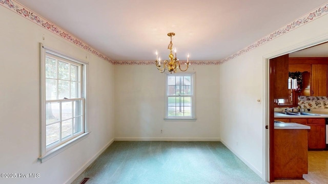 707 S Claiborne St, Goldsboro, NC 27530 - spare room with healthy amount of natural light, a chandelier, and light carpet
