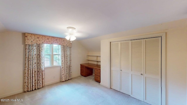707 S Claiborne St, Goldsboro, NC 27530 - unfurnished bedroom featuring lofted ceiling, carpet flooring, a closet, and built in desk