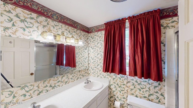 707 S Claiborne St, Goldsboro, NC 27530 - bathroom with wallpapered walls and double vanity
