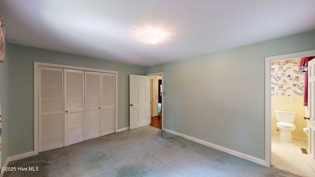 707 S Claiborne St, Goldsboro, NC 27530 - unfurnished bedroom featuring carpet flooring, a closet, and ensuite bathroom