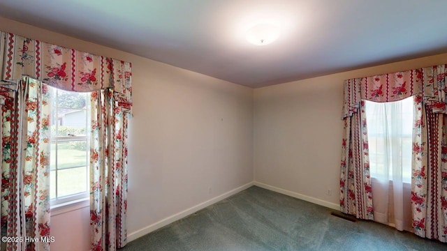 707 S Claiborne St, Goldsboro, NC 27530 - carpeted empty room featuring plenty of natural light