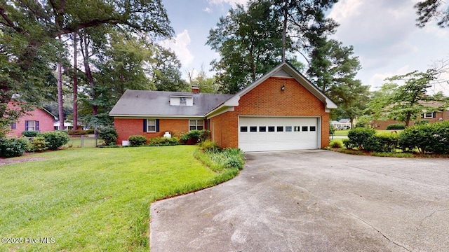 707 S Claiborne St, Goldsboro, NC 27530 - traditional-style home with brick siding, an attached garage, a front lawn, a chimney, and concrete driveway