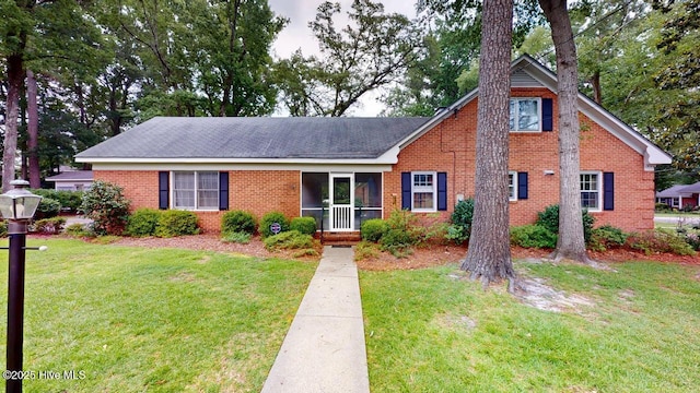 707 S Claiborne St, Goldsboro, NC 27530 - view of front facade featuring a front lawn and brick siding