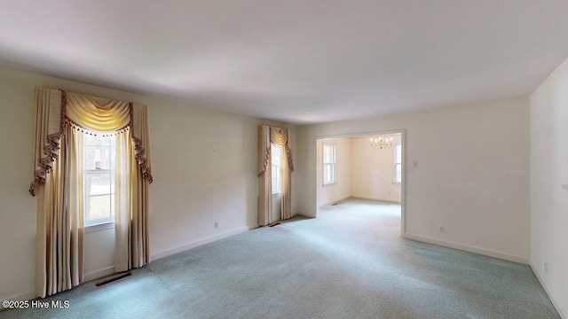 707 S Claiborne St, Goldsboro, NC 27530 - unfurnished room featuring a chandelier and carpet flooring