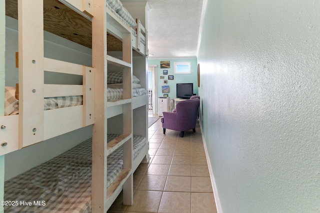 2224 New River Inlet Rd Unit 233, North Topsail Beach, NC 28460 - corridor with a textured wall and light tile patterned floors