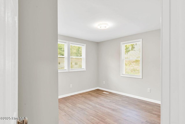 721 New River Dr, Jacksonville, NC 28540 - spare room featuring plenty of natural light and wood finished floors