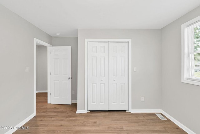 721 New River Dr, Jacksonville, NC 28540 - unfurnished bedroom featuring light wood-style floors and a closet