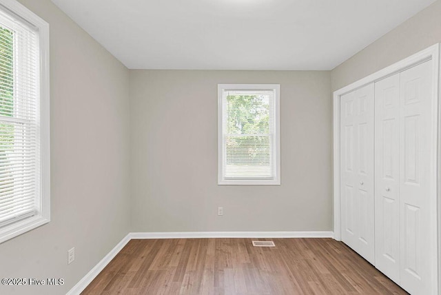 721 New River Dr, Jacksonville, NC 28540 - unfurnished bedroom featuring wood finished floors and a closet