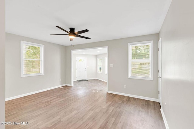 721 New River Dr, Jacksonville, NC 28540 - empty room featuring a ceiling fan, light wood-style floors, and plenty of natural light