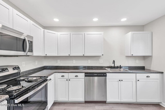 721 New River Dr, Jacksonville, NC 28540 - kitchen featuring appliances with stainless steel finishes, light wood-type flooring, white cabinets, and recessed lighting