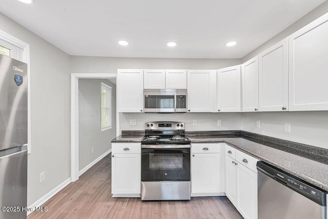721 New River Dr, Jacksonville, NC 28540 - kitchen with appliances with stainless steel finishes, white cabinetry, light wood-style flooring, and recessed lighting