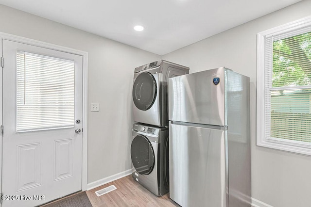 721 New River Dr, Jacksonville, NC 28540 - washroom featuring stacked washing machine and dryer, light wood-type flooring, and recessed lighting