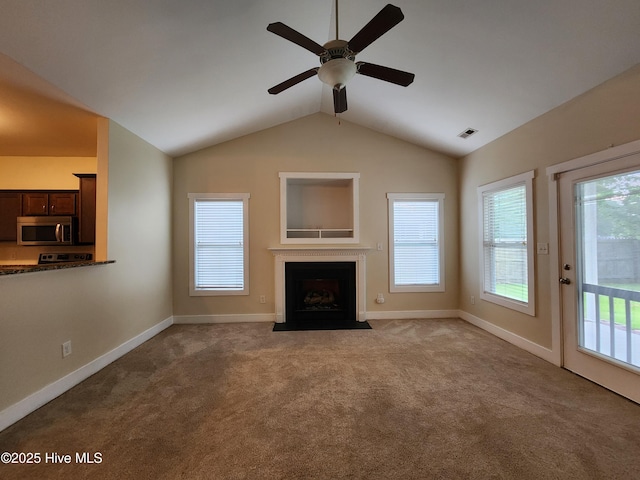 205 Channel Marker Loop, Swansboro, NC 28584 - unfurnished living room with a fireplace with flush hearth, vaulted ceiling, a ceiling fan, and carpet