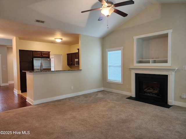 205 Channel Marker Loop, Swansboro, NC 28584 - unfurnished living room with carpet flooring, a ceiling fan, lofted ceiling, and a fireplace with flush hearth