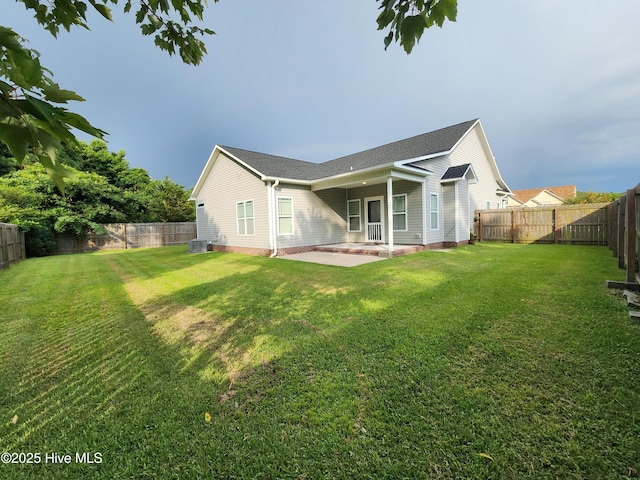 205 Channel Marker Loop, Swansboro, NC 28584 - back of house featuring a patio area, a fenced backyard, and a shingled roof