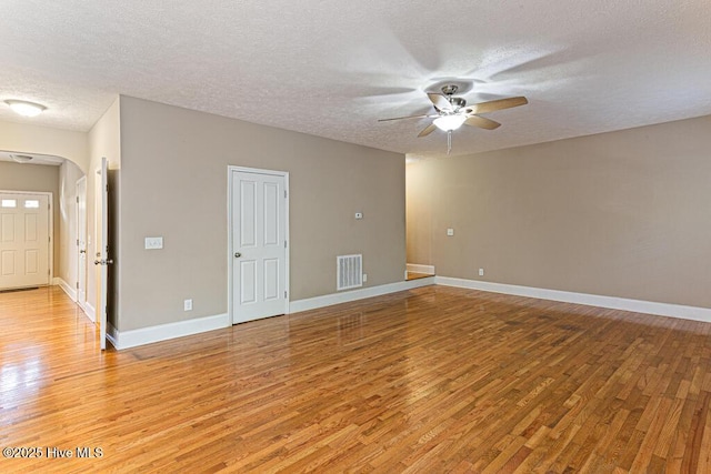 3 S Ct, Pinehurst, NC 28374 - unfurnished room with ceiling fan, light wood-style floors, a textured ceiling, and arched walkways