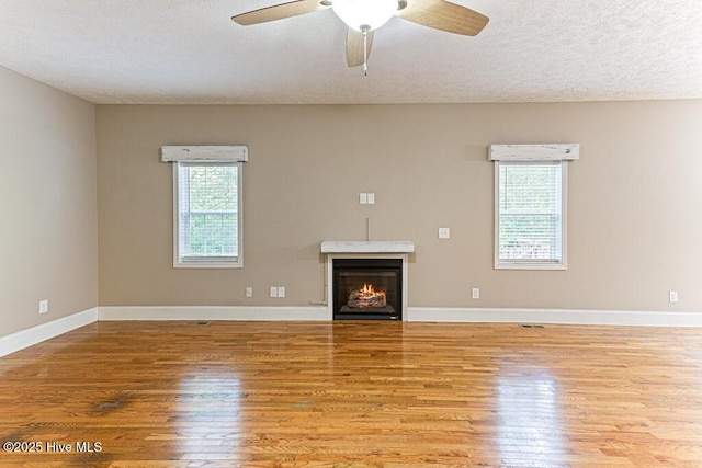 3 S Ct, Pinehurst, NC 28374 - unfurnished living room with wood finished floors, healthy amount of natural light, a ceiling fan, and a textured ceiling