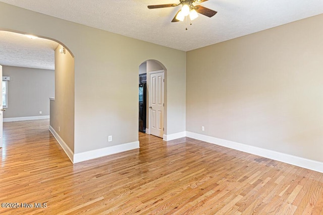 3 S Ct, Pinehurst, NC 28374 - empty room featuring ceiling fan, a textured ceiling, light wood-style floors, and arched walkways