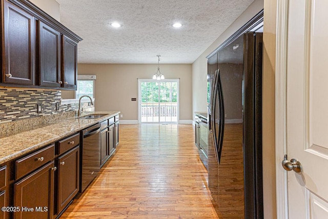 3 S Ct, Pinehurst, NC 28374 - kitchen featuring freestanding refrigerator, dishwasher, a textured ceiling, light wood-type flooring, and dark brown cabinets