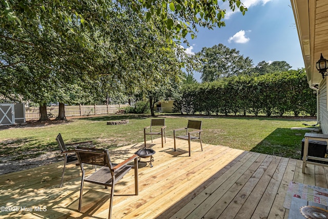 306 Goldleaf Dr, Goldsboro, NC 27534 - deck featuring a fire pit, a fenced backyard, and a storage shed