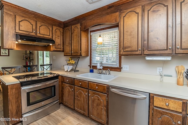 306 Goldleaf Dr, Goldsboro, NC 27534 - kitchen with appliances with stainless steel finishes, under cabinet range hood, light countertops, a peninsula, and a textured ceiling