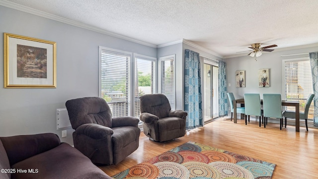800 Saint Andrews Dr # 156, Pinehurst, NC 28374 - living area featuring wood finished floors, a textured ceiling, crown molding, and ceiling fan