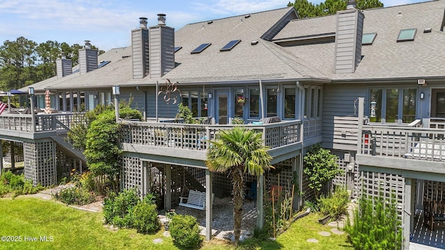 117 Forecastle Ct, Washington, NC 27889 - back of house featuring stairway, a deck, a chimney, and roof with shingles