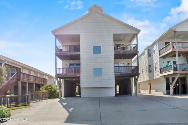 1711 Carolina Beach Ave N Unit B, Carolina Beach, NC 28428 - view of building exterior with concrete driveway and a carport