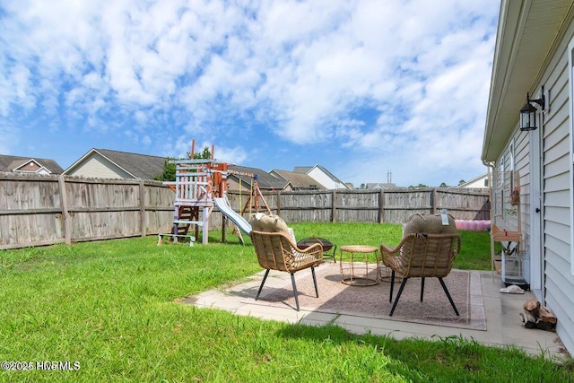 939 Dynamo Ln, Jacksonville, NC 28546 - fenced backyard featuring a playground and a patio