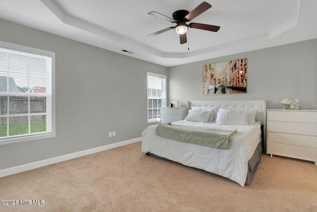 939 Dynamo Ln, Jacksonville, NC 28546 - carpeted bedroom featuring a raised ceiling and ceiling fan