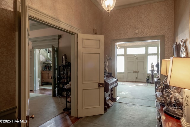 900 Nash St N, Wilson, NC 27893 - entrance foyer featuring crown molding, wallpapered walls, a towering ceiling, and carpet floors