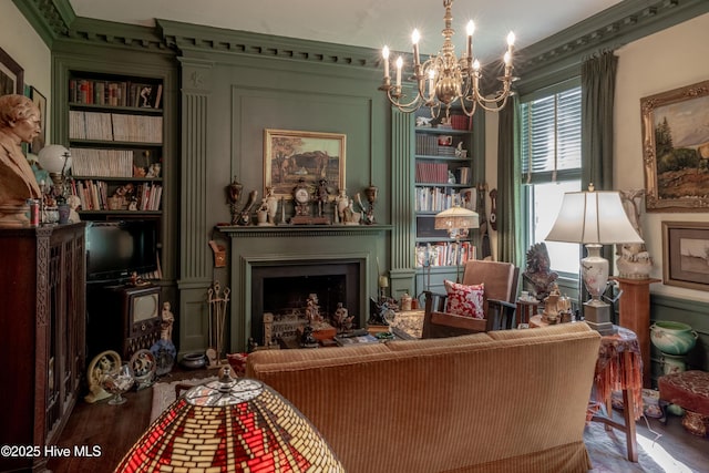 900 Nash St N, Wilson, NC 27893 - living area featuring a chandelier, wood finished floors, ornamental molding, a fireplace, and built in features