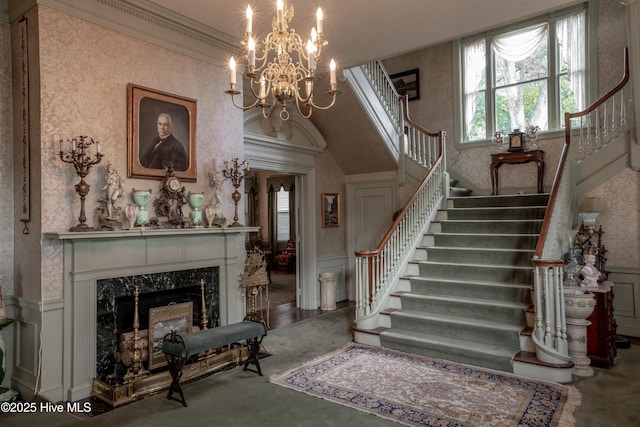 900 Nash St N, Wilson, NC 27893 - staircase featuring wainscoting, crown molding, a decorative wall, wallpapered walls, and a high end fireplace