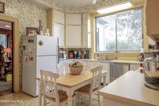 900 Nash St N, Wilson, NC 27893 - kitchen featuring appliances with stainless steel finishes, light countertops, and wallpapered walls